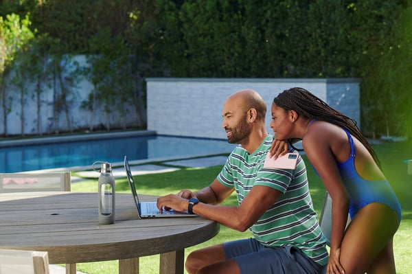 Family in backyard looking at laptop in Dunnellon